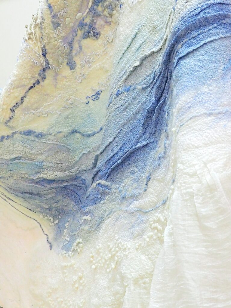 The texture of felted wool, handmade fabric of silk and merino wool